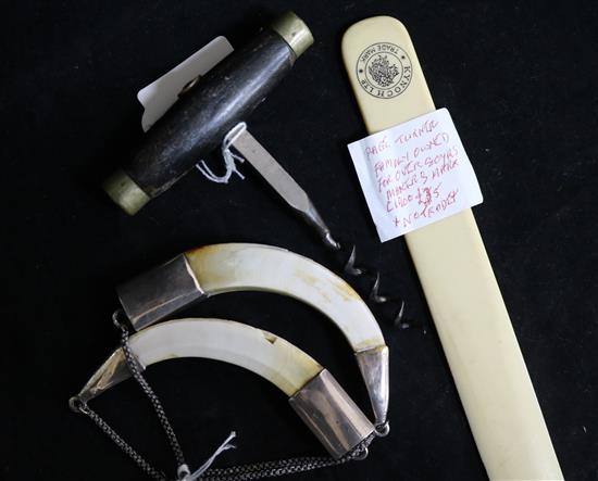 A pair of 19th century Indian white metal mounted boars tusk wine labels, a corkscrew and a page turner